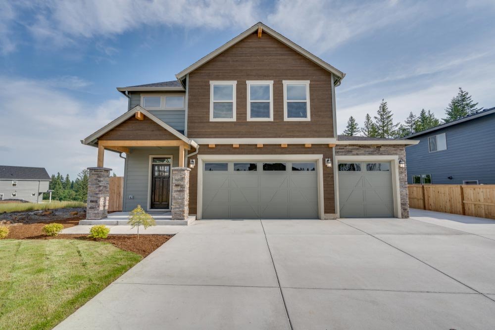 Home homeguide contractors installing new plain gray concrete driveway